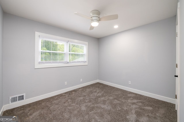 unfurnished room with ceiling fan and carpet