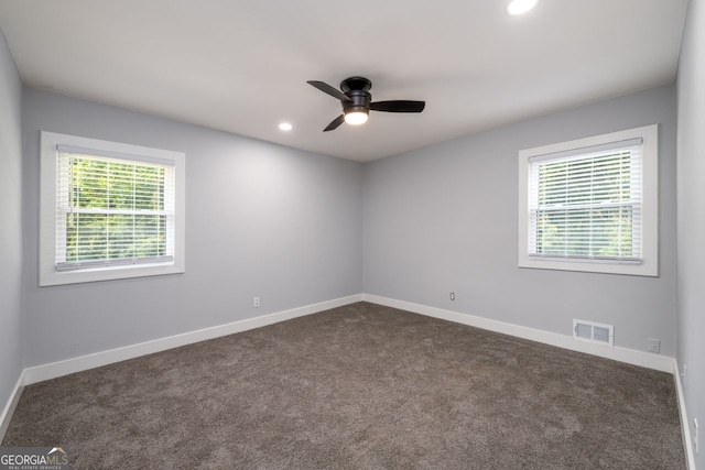 spare room with a healthy amount of sunlight, ceiling fan, and carpet