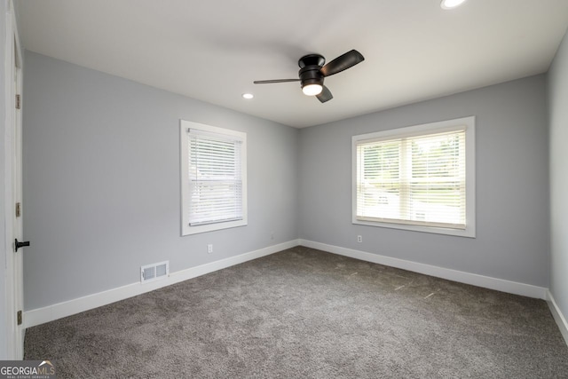 spare room featuring ceiling fan and carpet floors