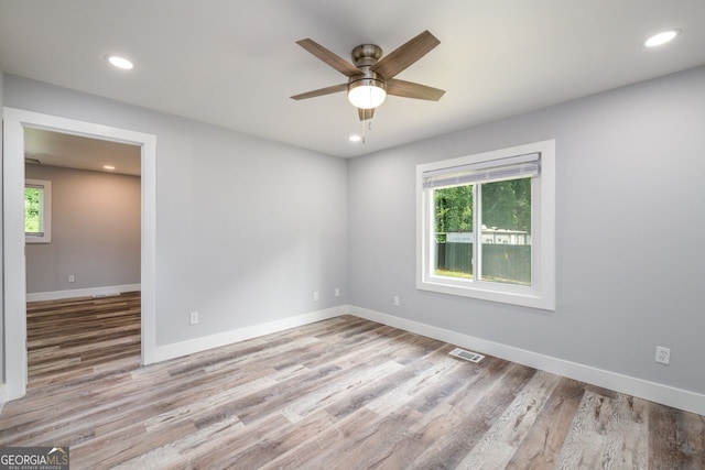 unfurnished room with ceiling fan and hardwood / wood-style flooring