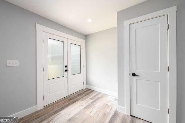 entryway with light hardwood / wood-style floors