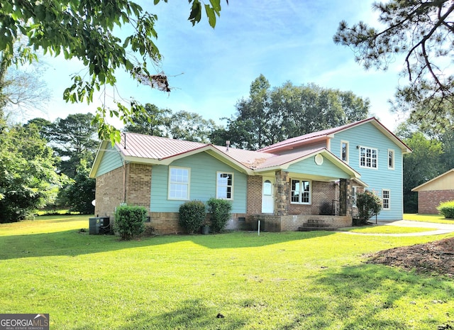 view of front facade featuring central air condition unit and a front lawn