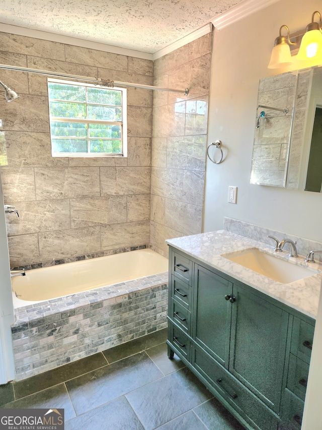 bathroom with vanity, a textured ceiling, tiled shower / bath combo, and tile patterned flooring