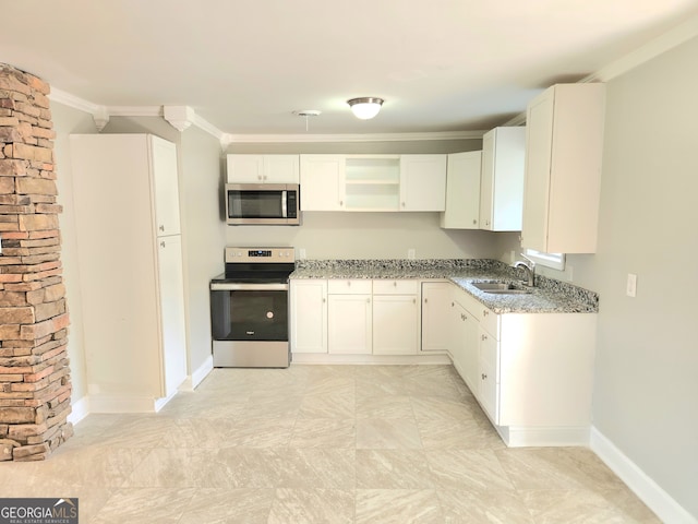 kitchen featuring crown molding, light tile patterned floors, light stone countertops, appliances with stainless steel finishes, and sink