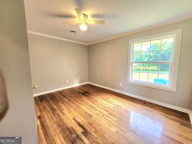 spare room with wood-type flooring, ceiling fan, and crown molding