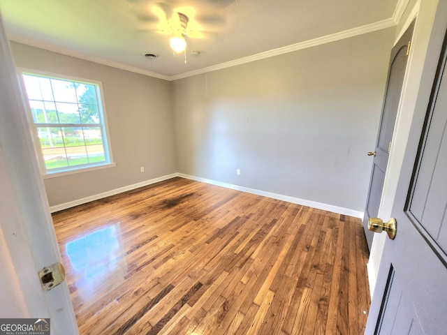 unfurnished room with wood-type flooring, crown molding, and ceiling fan