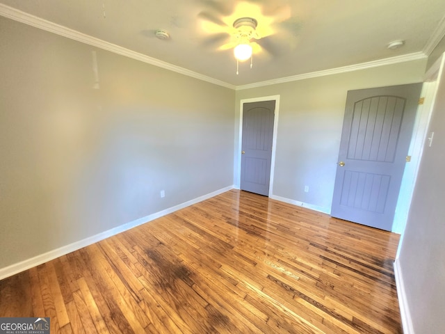 unfurnished bedroom featuring wood-type flooring, crown molding, and ceiling fan