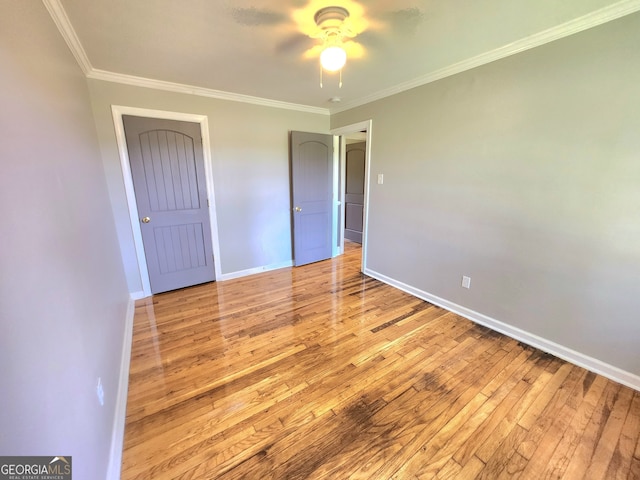 interior space with crown molding, light hardwood / wood-style flooring, and ceiling fan