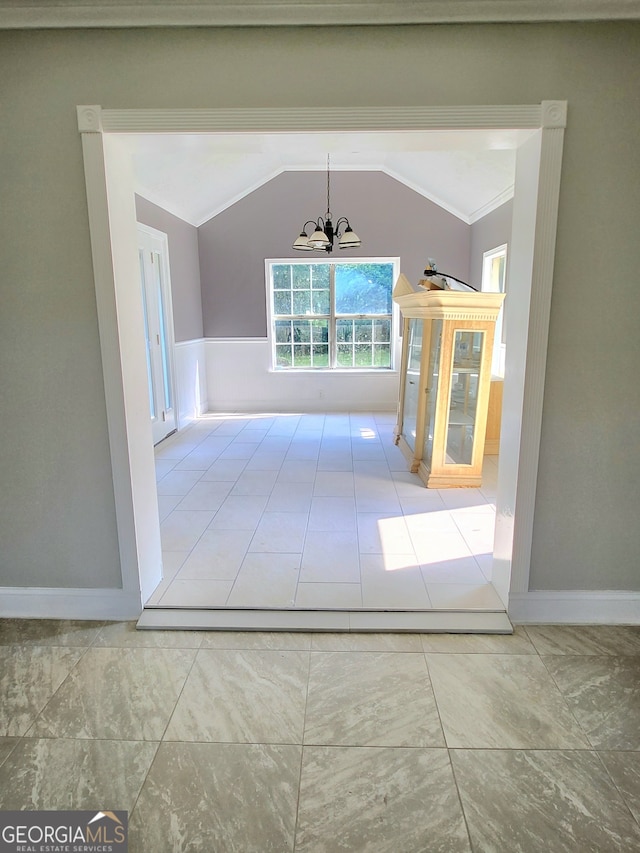 hallway featuring vaulted ceiling, crown molding, tile patterned flooring, and a notable chandelier