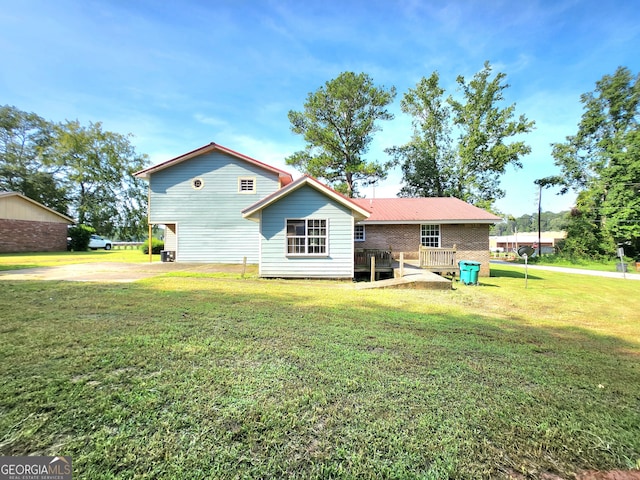 back of property featuring a yard