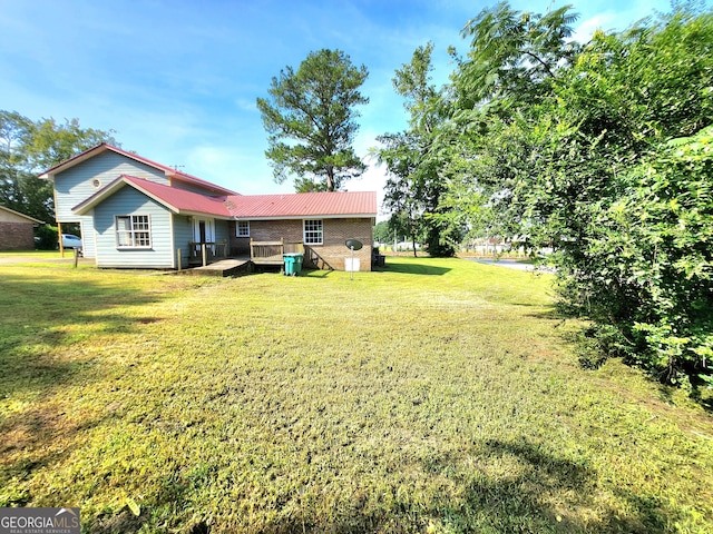 view of yard with a wooden deck