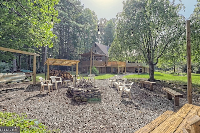 view of yard featuring an outdoor fire pit