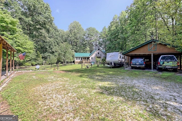 view of yard featuring a garage and an outbuilding