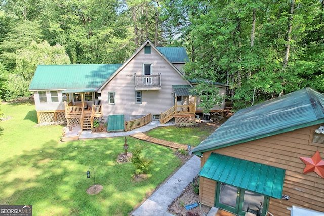 rear view of property with a lawn