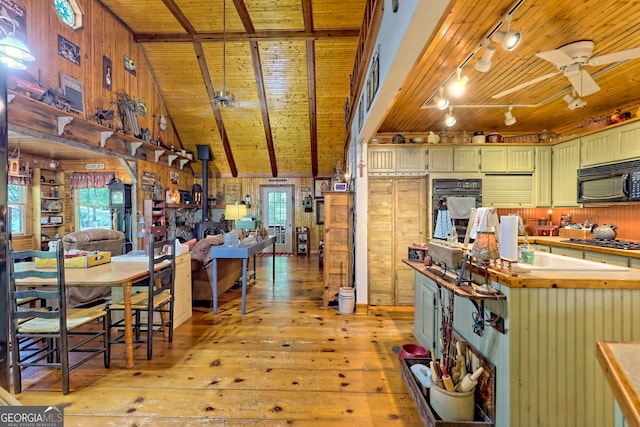 kitchen featuring black appliances, ceiling fan, light wood-type flooring, wooden walls, and wood ceiling