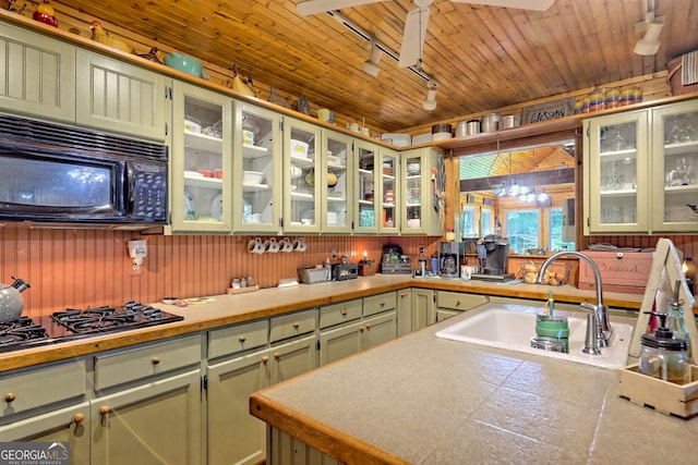 kitchen with black appliances, wood ceiling, sink, green cabinetry, and ceiling fan