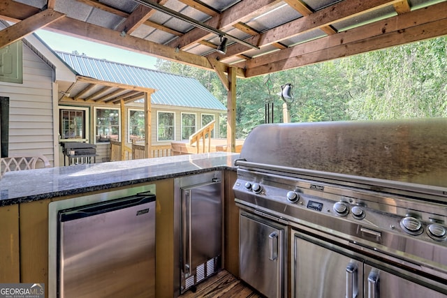 view of patio / terrace with an outdoor kitchen and a grill