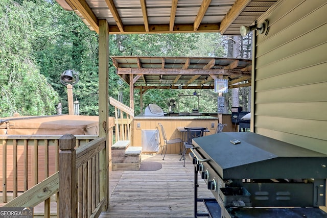 deck featuring a pergola and a grill