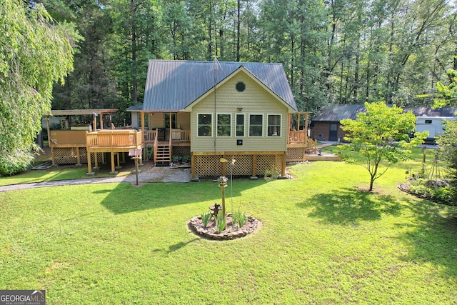 back of house featuring a yard and a wooden deck