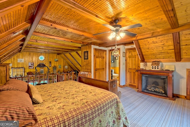 bedroom featuring lofted ceiling with beams, wooden walls, and wooden ceiling