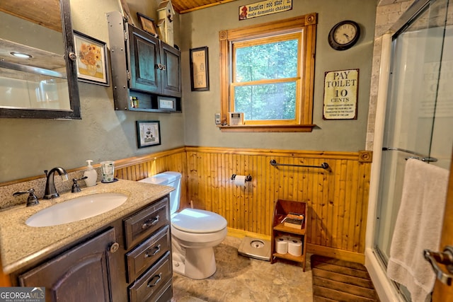 bathroom with wood walls, vanity, walk in shower, and toilet