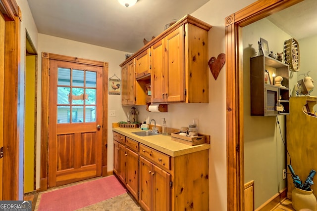 kitchen featuring sink and light tile patterned flooring