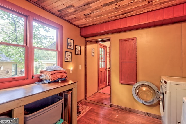 interior space with washer / clothes dryer, a wealth of natural light, light wood-type flooring, and wood ceiling