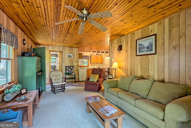 living room featuring wood walls, wooden ceiling, light colored carpet, and ceiling fan