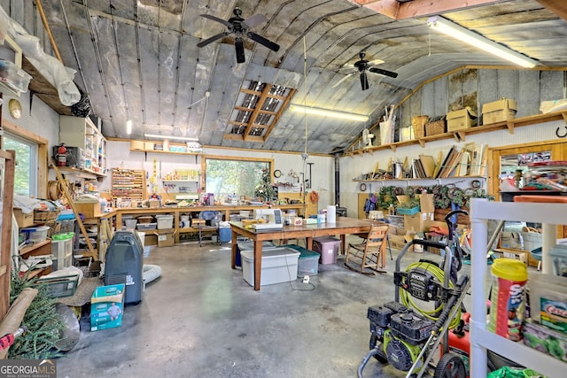 garage featuring ceiling fan and a workshop area