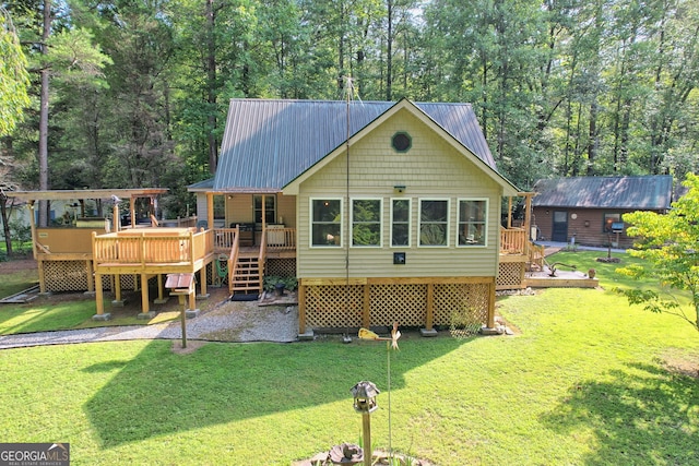 back of property featuring a yard and a wooden deck