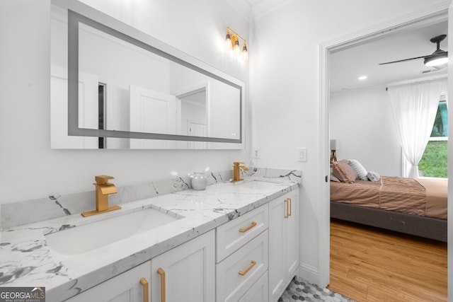 bathroom with ceiling fan, hardwood / wood-style floors, and double vanity