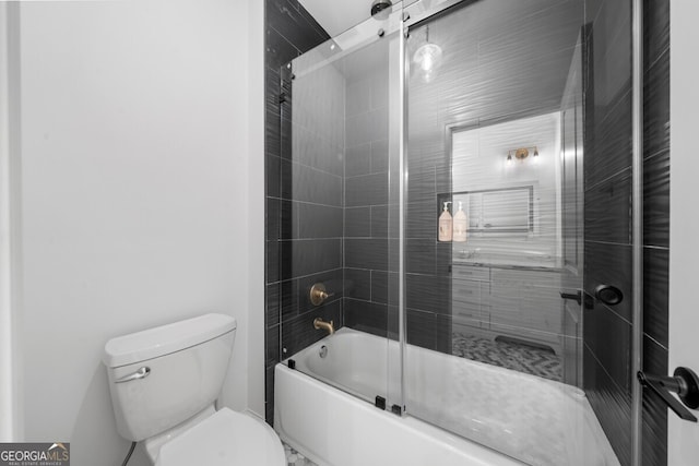 bathroom with shower / bath combination with glass door and toilet