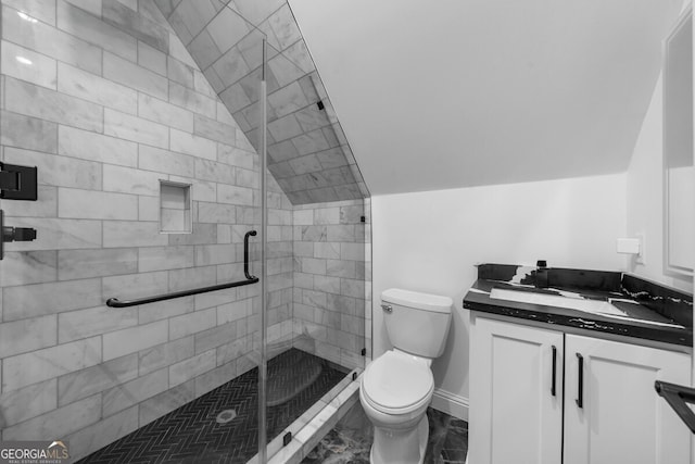 bathroom with tile patterned flooring, a shower with shower door, toilet, vanity, and vaulted ceiling