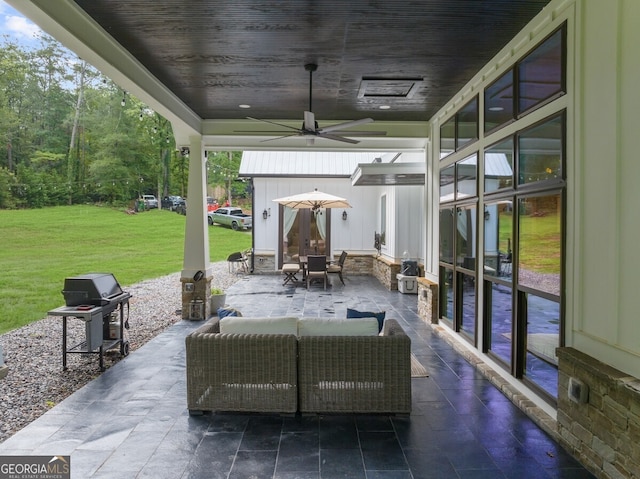 view of patio with an outdoor living space and ceiling fan