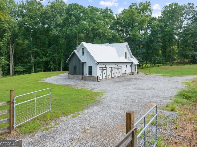 exterior space featuring an outdoor structure and a front yard