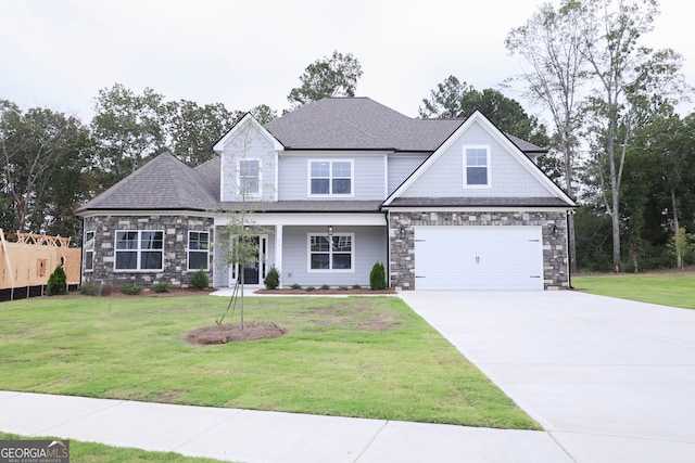 view of front of home with a front yard and a garage