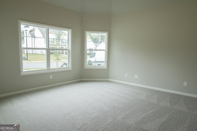 carpeted empty room featuring plenty of natural light