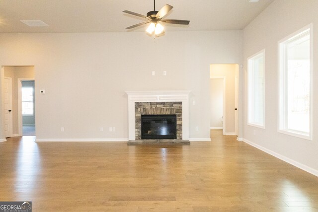 spare room featuring a barn door, ceiling fan, and dark hardwood / wood-style flooring