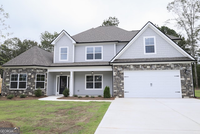 craftsman-style house featuring a garage and a front lawn