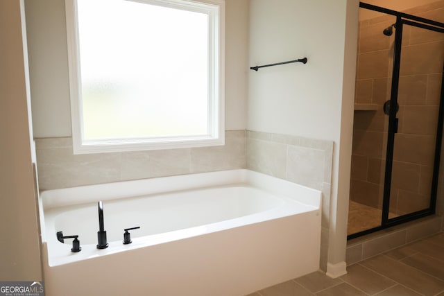 bathroom featuring tile patterned floors and plus walk in shower