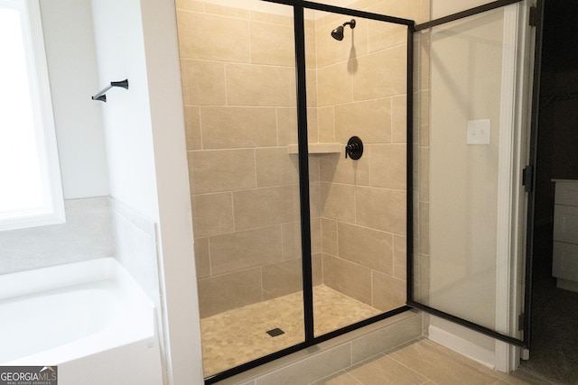 bathroom featuring tile patterned flooring and independent shower and bath