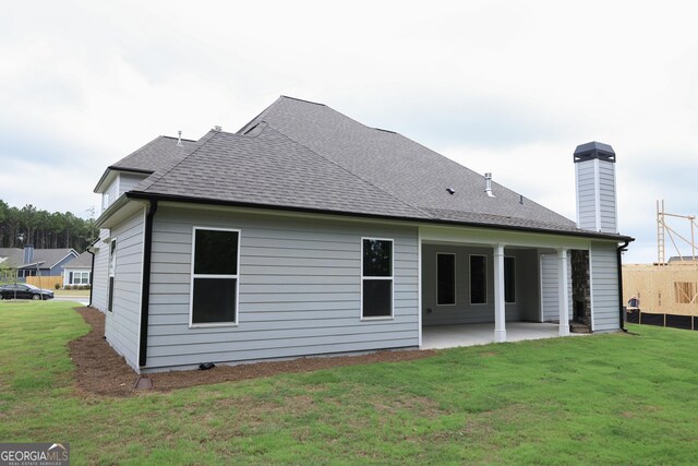 back of house with a lawn, central air condition unit, and a patio