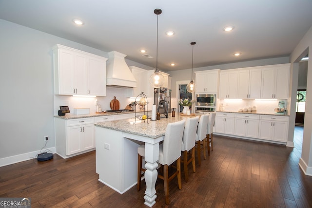 kitchen featuring custom exhaust hood, dark hardwood / wood-style floors, and white cabinetry