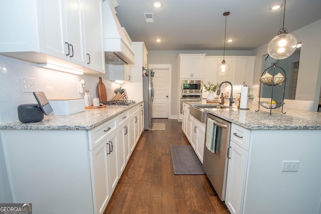 kitchen featuring white cabinetry, dark wood-type flooring, pendant lighting, appliances with stainless steel finishes, and custom exhaust hood