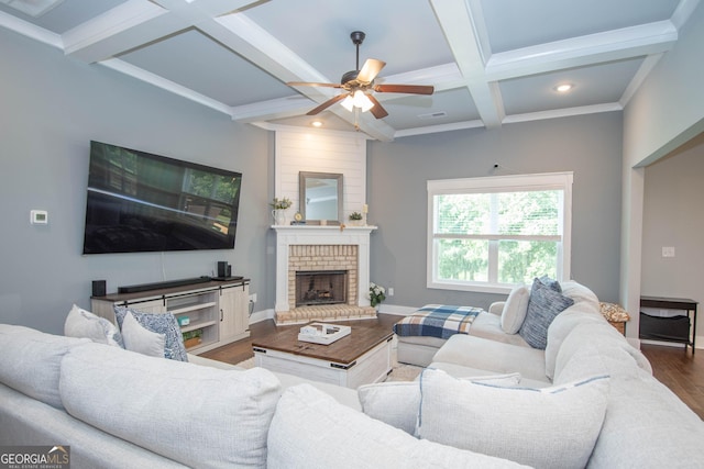 living room with coffered ceiling, hardwood / wood-style flooring, ceiling fan, a fireplace, and beam ceiling