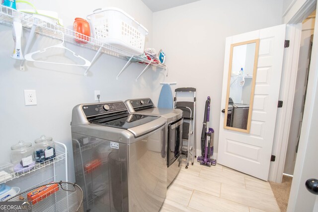 clothes washing area with independent washer and dryer