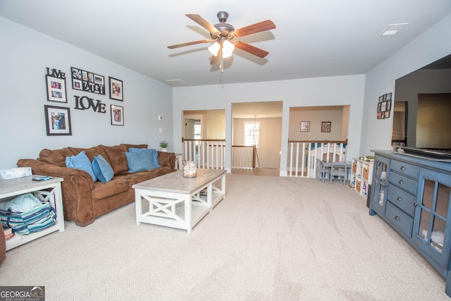 living room featuring ceiling fan and light carpet