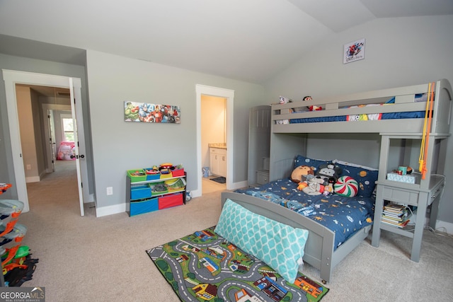 bedroom with light carpet, connected bathroom, and lofted ceiling