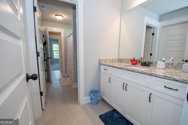 bathroom with vanity and hardwood / wood-style flooring