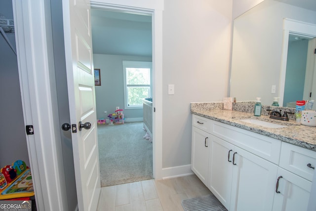 bathroom featuring vanity and wood-type flooring